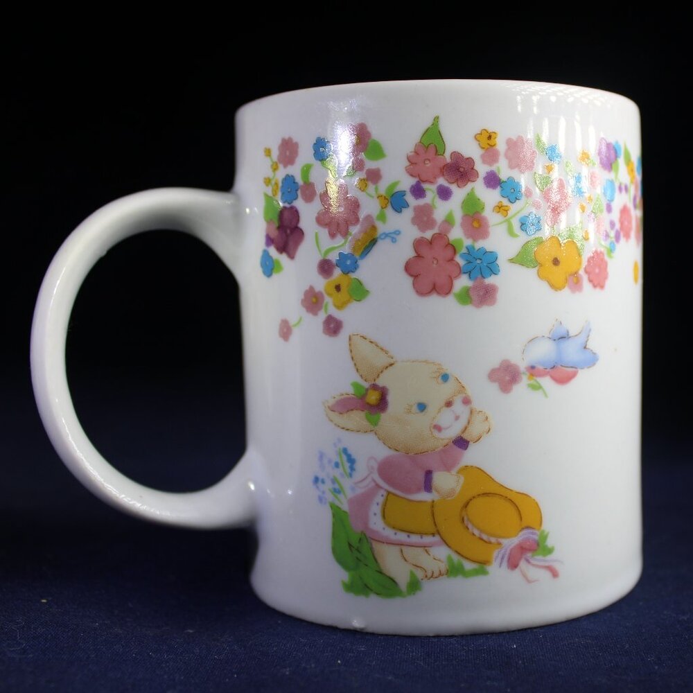 Three Playful Bunnies Cavort on a Colorful Easter Mug by Houston Foods